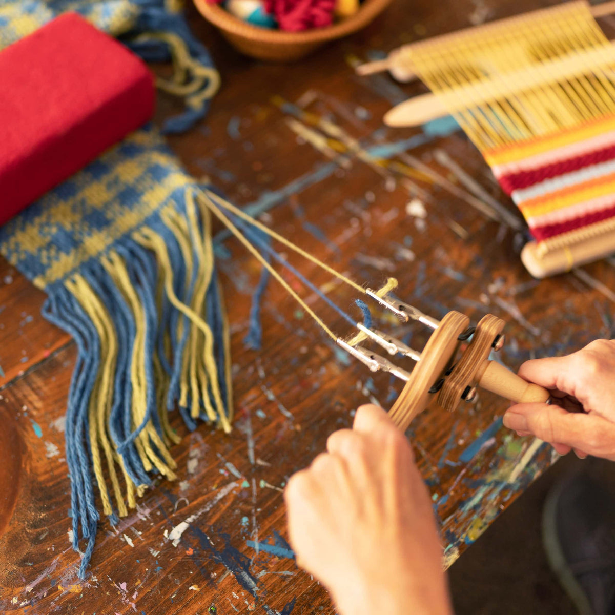 Twisting the ends of handwoven fabric with a fringe twister